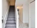 View of the entryway with a staircase, tiled floor, and a coat closet at 12148 E Kepner Pl, Aurora, CO 80012