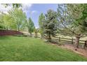 Well-maintained backyard with a green lawn and a wooden fence providing privacy at 16671 E Prairie Goat Ave, Parker, CO 80134