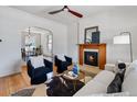 Bright living room featuring a fireplace, hardwood floors, ceiling fan, and stylish furniture at 16 N Pennsylvania St, Denver, CO 80203