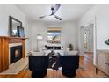 Cozy living room with a fireplace, hardwood floors, ceiling fan, and comfortable seating at 16 N Pennsylvania St, Denver, CO 80203
