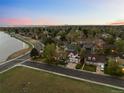 Aerial view of a home near a lake with landscaped front yard and inviting curb appeal in a quiet neighborhood at 6402 W 81St Ave, Arvada, CO 80003