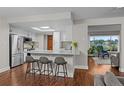 Bright, open kitchen featuring a skylight, breakfast bar with seating, and stainless steel appliances at 6402 W 81St Ave, Arvada, CO 80003