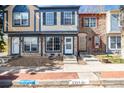 Charming townhome showcasing a stone foundation, blue and tan siding, and a well-maintained brick sidewalk at 2927 W 81St Ave # B, Westminster, CO 80031