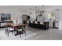 Bright kitchen featuring an island with seating, stainless steel appliances, and ample counter space at 8249 Zephyr St, Arvada, CO 80005