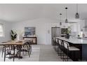 Spacious kitchen and dining area with a large island and modern decor at 8249 Zephyr St, Arvada, CO 80005