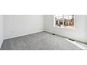 Bright bedroom featuring neutral carpeting and a large window for natural light at 9112 Telluride Ct, Commerce City, CO 80022
