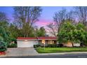 Attractive single-story home with a two car garage, manicured lawn, and mature trees at 7900 Crest Dr, Lakewood, CO 80214