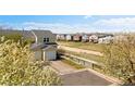 A row of townhomes stand along the green common area and walking path at 7841 S Kalispell Cir, Englewood, CO 80112
