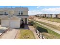 Charming townhome boasts a single-car garage, neat landscaping, and a welcoming entrance at 7841 S Kalispell Cir, Englewood, CO 80112