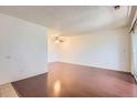 Spacious living room features hardwood floors and a ceiling fan at 10762 E Exposition Ave # 336, Aurora, CO 80012