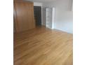 Bright living area boasts hardwood floors, a Murphy bed, and a shelving unit for storage at 1131 N Lafayette St # 304, Denver, CO 80218