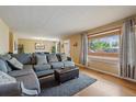 Spacious living room that flows into dining area, featuring hardwood floors and comfortable seating at 4855 E Atlantic Pl, Denver, CO 80222