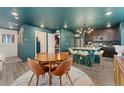 Cozy dining area featuring a round table and stylish seating, open to the kitchen and living space at 18552 E 54Th Ave, Denver, CO 80249