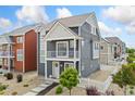 Two-story home with balcony, landscaped front yard, and stylish exterior features at 18552 E 54Th Ave, Denver, CO 80249