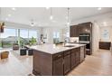Open concept kitchen with a large island, modern appliances, and access to a spacious living area at 22183 E Rocky Top Pl, Aurora, CO 80016
