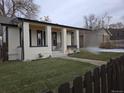 Updated bungalow features a covered front porch and a fenced front yard at 720 Raleigh St, Denver, CO 80204