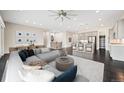 Spacious living room with modern furniture, a stylish rug, and an open concept design at 6725 Mentha Dr, Castle Rock, CO 80108