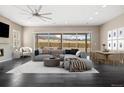 Bright living room with floor-to-ceiling windows, a cozy seating area, and outdoor views at 6725 Mentha Dr, Castle Rock, CO 80108