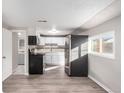 Bright kitchen with white cabinets, stainless steel appliances, and stylish countertops, offering a modern and clean design at 1050 S Raleigh St, Denver, CO 80219