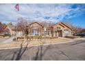 Exterior shot of the clubhouse with manicured landscaping and an American flag waving at 17525 Wilde Ave # 307, Parker, CO 80134