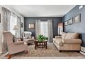 Inviting living room with stylish decor, ample natural light, and comfortable seating at 3383 Willowrun Dr, Castle Rock, CO 80109