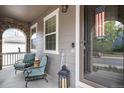 Cozy front porch with chairs, brick accents, and a 'welcome' sign, creating an inviting entry at 2828 Shadow Dance Dr, Castle Rock, CO 80109
