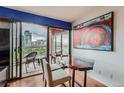 A wooden desk and seating open to a city balcony view at 100 W Park Ave Ave # 908, Denver, CO 80205