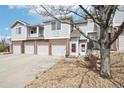 Charming two-story townhome with a well-manicured front yard and attached garages at 10259 W 55Th Dr # 103, Arvada, CO 80002