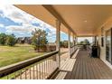 Covered back porch with ample space for outdoor dining and relaxation at 895 Antelope W Dr, Bennett, CO 80102
