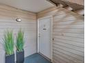 Apartment 7 has a tidy front entrance with wood-look siding and greenery at 3613 S Sheridan Blvd # 7, Denver, CO 80235