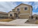 Charming two-story home with stone accents, a two-car garage, and a welcoming front door with a wreath at 14799 Longhorn Dr, Mead, CO 80542