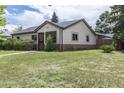 View of the single-story home with beige siding and a well-kept lawn at 1099 Wheeling St, Aurora, CO 80011