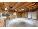 Spacious unfinished garage with concrete flooring and overhead door at 1099 Wheeling St, Aurora, CO 80011