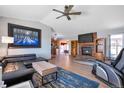 Bright and airy living room with wood floors, brick fireplace, ceiling fan, and stylish furnishings at 2372 Haskell Way, Watkins, CO 80137