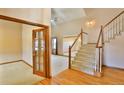 Inviting entryway with hardwood floors, staircase, and view into formal living room at 288 Dover Ct, Broomfield, CO 80020