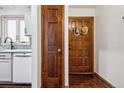 Inviting hallway with wood doors, decorative hats and a tiled floor, near to the white kitchen cabinets at 3355 Hickok Pl, Boulder, CO 80301