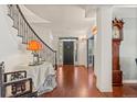 Entryway with hardwood floors, staircase, and a dark front door at 344 Saint Paul St, Denver, CO 80206