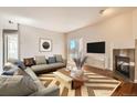 Bright living room featuring a cozy fireplace, modern furniture and a sliding glass door at 875 E 78Th Ave # 9-2, Denver, CO 80229