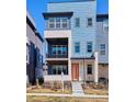 Contemporary townhome with a second story balcony, and stylish blue and grey siding at 6240 N Dayton Ct, Denver, CO 80238