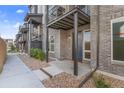 Brick facade townhouse with metal porch covers and low-maintenance gravel landscaping at 5173 Vivian St, Wheat Ridge, CO 80033