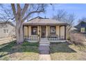 Inviting bungalow with covered porch, perfect for enjoying quiet mornings at 306 E Cannon St, Lafayette, CO 80026