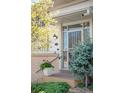 Inviting entryway with brick accents, decorative security door and landscaped garden at 12662 W Asbury Pl, Lakewood, CO 80228