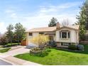 Well-maintained home with manicured lawn and mature trees at 12662 W Asbury Pl, Lakewood, CO 80228