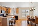 Bright eat-in kitchen boasts a breakfast bar, sleek black appliances, and ample cabinet space at 835 Stony Mesa Pl, Castle Rock, CO 80108