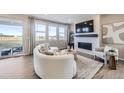 Cozy living room with a fireplace, large windows for natural light, and comfortable seating at 4096 Estrella St, Brighton, CO 80601