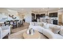 Open-concept living space featuring a modern kitchen, dining area, and a comfortable living room at 4096 Estrella St, Brighton, CO 80601