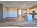 Spacious living room with hardwood floors, a stylish fireplace, and an open-concept design connecting to the kitchen at 5930 S Platte Canyon Dr, Littleton, CO 80123