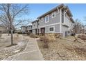 Townhome exterior featuring a sidewalk, stone accents, and low-maintenance landscaping at 17224 Lark Water Ln # D, Parker, CO 80134