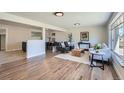 Open-concept living room featuring hardwood floors and plenty of natural light at 6923 S Albion St, Centennial, CO 80122