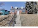 Charming brick home featuring black shutters and a long staircase leading to the entrance at 525 W Midway Blvd, Broomfield, CO 80020